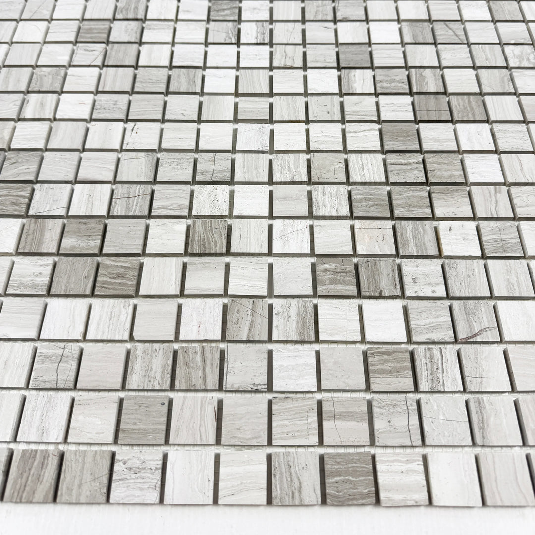 Mosaic tile pattern with small square tiles in various shades of gray.