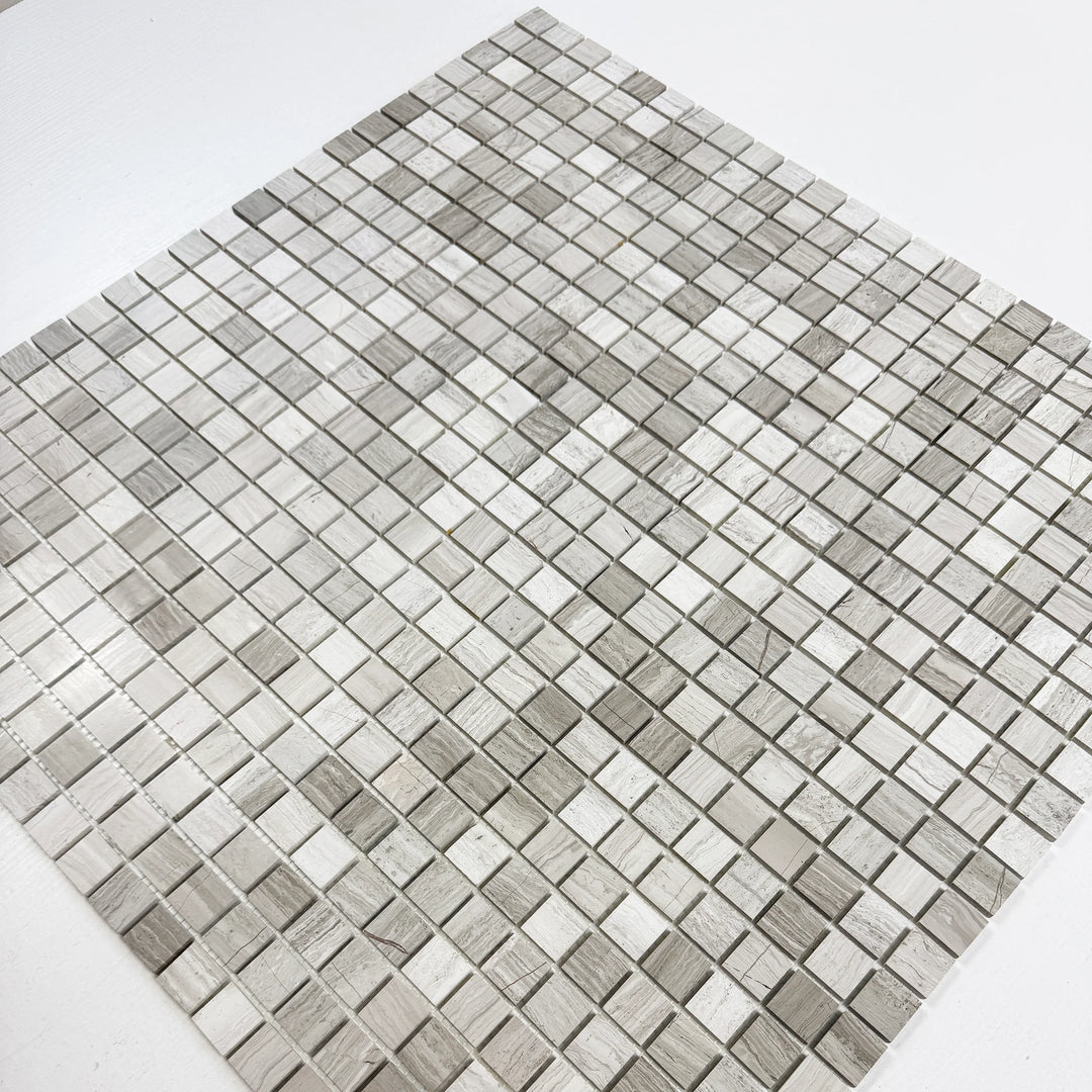 Mosaic tile pattern with gray and white squares on a white background