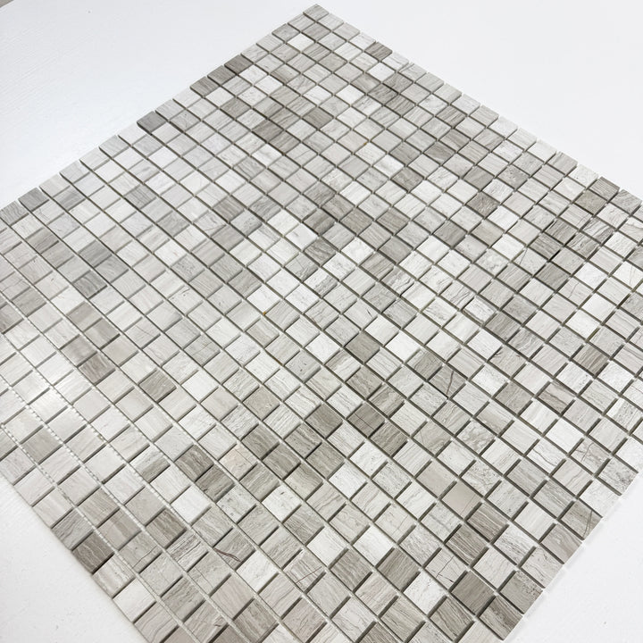 Mosaic tile pattern with gray and white squares on a white background