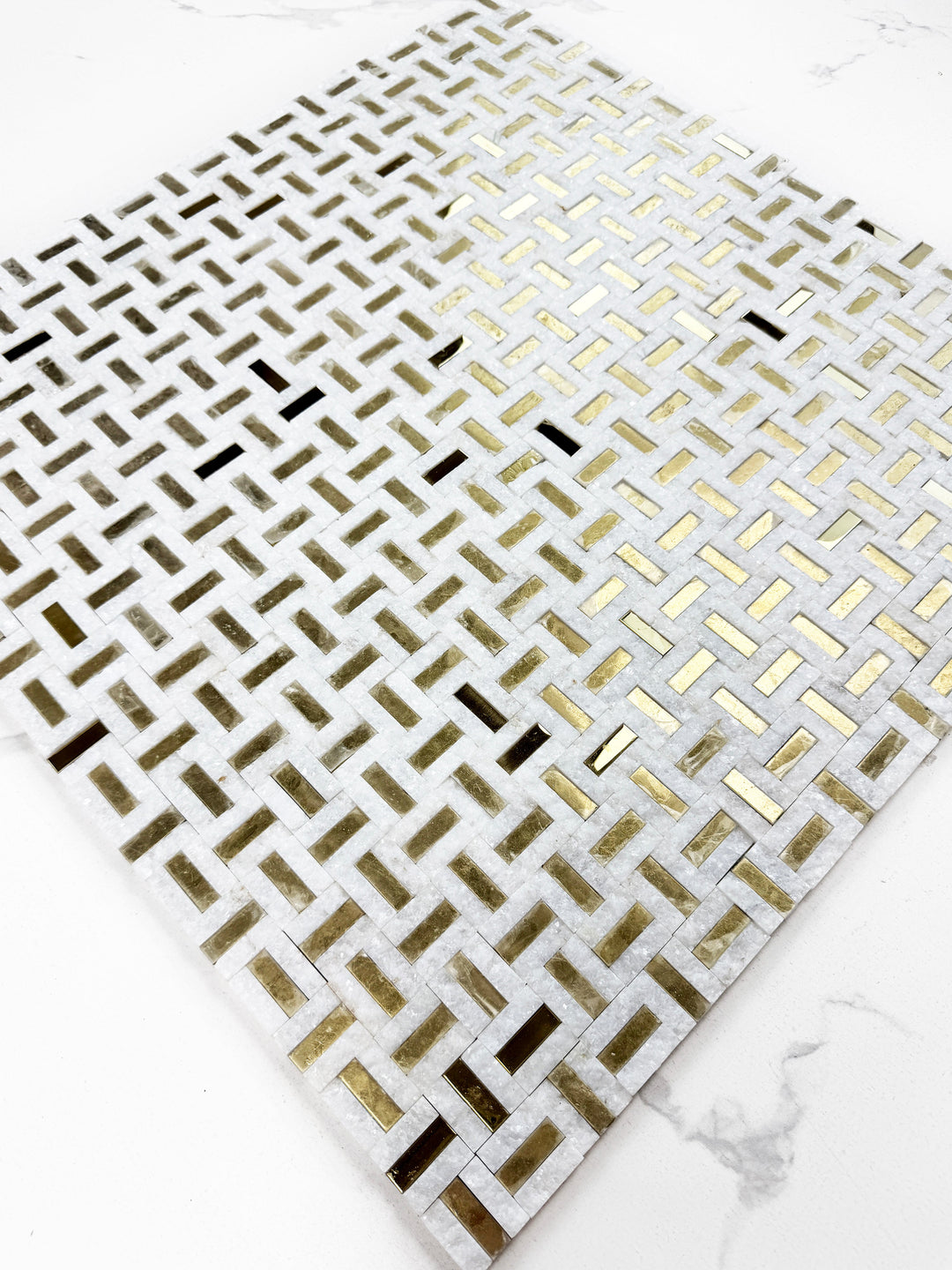 White marble mosaic with gold stainless steel split surface