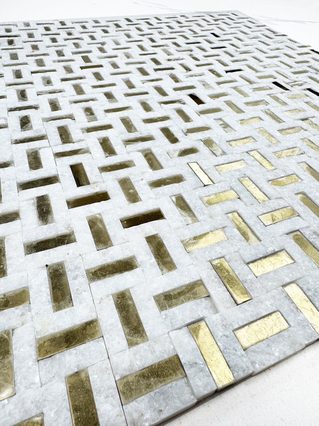 White marble mosaic with gold stainless steel split surface
