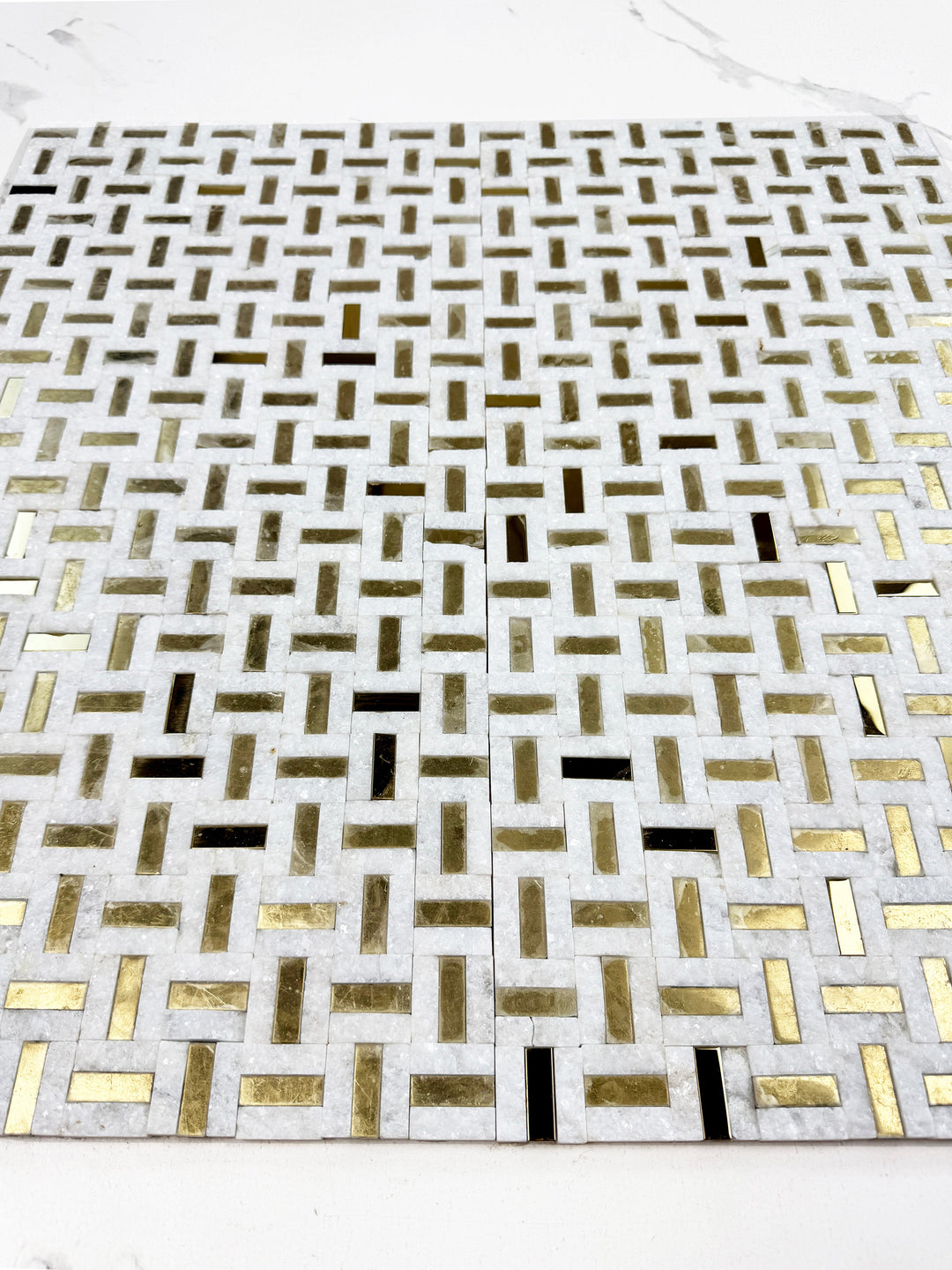 White marble mosaic with gold stainless steel split surface
